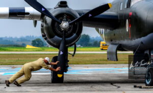 Aviation photography - This shot of Flight Engineer Bill Rouw adjusting the propellor of the North American B-25J Mitchell Mk. III was one of 10 finalists in the "People and Planes" category of the SMITHSONIAN AIR AND SPACE MAGAZINE aviation photo contest open to photographers worldwide. I was the only Canadian finalist out of 50 photographers, 10 in each of five categories. 
(C)Anita Thomas All Rights Reserved. b mitchell