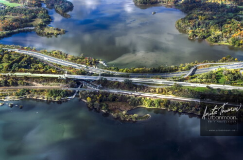 Aerial photography - Light dance on the gates to the city: The Dundurn area of Hamilton with Cootes Paradise, Lake Ontario, Highway 403, York Blvd, the rail line and more, all being danced upon by the beautiful light and clouds.
(C)Anita Thomas All Rights Reserved. aerial photography of cootes paradise