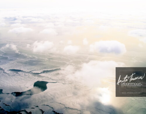 Aerial photography - Lake Erie in winter. Below puffy, small clouds is a frozen Lake Erie and its snow drifts on a cold -30C winter's day.
(C)Anita Thomas All Rights Reserved. aerial photography of lake erie in winter