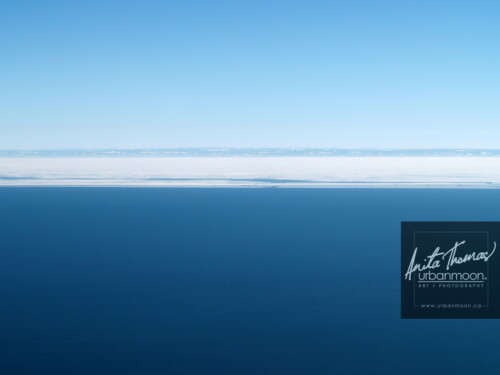 Aerial photography - Calm blue water of Lake Erie in winter meets frozen, snowy, shallow depths near the shore of Long Point in Southern Ontario, Canada.
(C)Anita Thomas All Rights Reserved. aerial photography of lake erie ontario