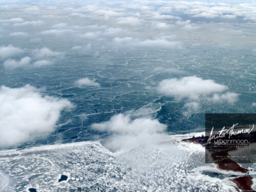 Aerial photography - Lake Erie and Long Point in winter. Below puffy, small clouds is a frozen Lake Erie and its snowdrifts on a cold -30C winter's day.
(C)Anita Thomas All Rights Reserved. aerial photography of long point