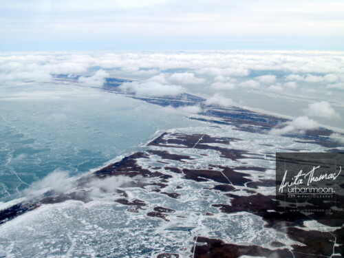 Aerial photography - Below puffy, small clouds is a frozen Lake Erie and its snowdrifts, with Long Point in the distance on a cold -30C winter's day.
(C)Anita Thomas All Rights Reserved. aerial photography of long point