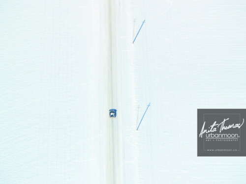 Aerial photography - A lone car on a mission.
(C)Anita Thomas All Rights Reserved. lone car on winter road