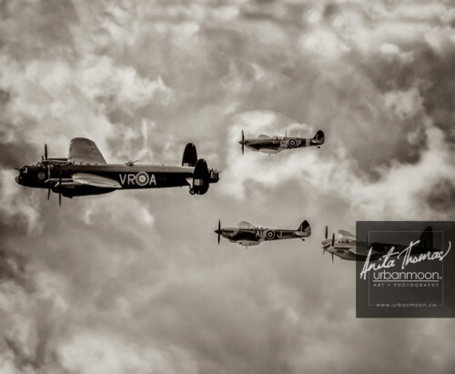 Aviation photography - The Avro Lancaster Mk. X bomber flies past during an airshow along with the world's only flying de Havilland DH-98 Mosquito, a Supermarine MK-1XE Spitfire, and a Supermarine Spitfire LF Mk. XVIe at the Canadian Warplane Heritage Museum in Hamilton, Ontario, Canada.
© Anita Thomas - Urbanmoon. All Rights Reserved. merlin formation