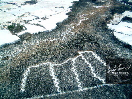 Aerial photography - A river forms zig-zag patterns in a forest in winter in Southern Ontario, Canada 
(C)Anita Thomas All Rights Reserved. patterns in a forest
