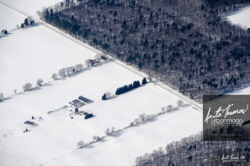 Aerial photography - The fields, all covered in snow, are at rest during a long winter in southern Ontario.
© Anita Thomas - Urbanmoon. All Rights Reserved. winter in rural ontario