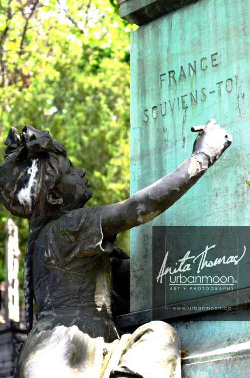 A child's statue writes on a tomb at Père Lachaise Cemetery in Paris, France
© Anita Thomas - Urbanmoon. All Rights Reserved. a child statue at a tomb at pere lachaise cemetery