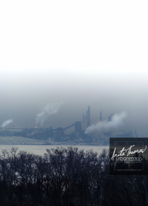Aerial photography - Through the haze of a cold winter's day, the industrial plant producing cold, hard steel if softened.
© Anita Thomas - Urbanmoon. All Rights Reserved. aerial photography of industry in hamilton