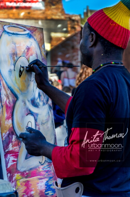 Lifestyle photography - Scenes captured of the performers and visitors at Supercrawl in Hamilton, Ontario.
© Anita Thomas - Urbanmoon Photography. All Rights Reserved. artist paints at event