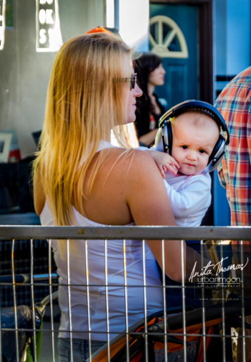 Lifestyle photography - A mother and baby enjoy the music at Supercrawl 2013 in Hamilton, Ontario. Scenes captured of the performers and visitors at Supercrawl in Hamilton, Ontario.
© Anita Thomas - Urbanmoon Photography. All Rights Reserved. baby at a concert