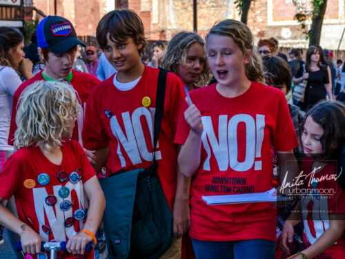 Lifestyle photography - NO Downtown Hamilton Casino - Getting the job done, collecting signatures for a petition at Supercrawl 2013 in Hamilton, Ontario. Scenes captured of the performers and visitors at Supercrawl in Hamilton, Ontario.
© Anita Thomas - Urbanmoon Photography. All Rights Reserved. children canvas for signatures