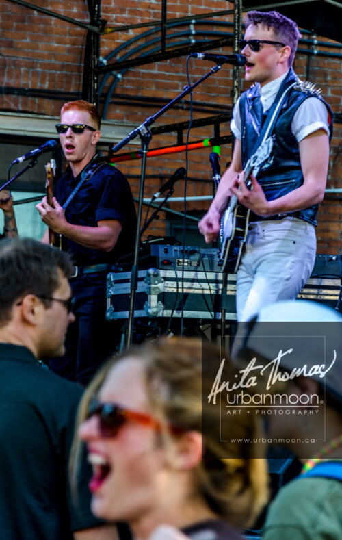 Lifestyle photography - Diamond Rings performs at Supercrawl 2013 in Hamilton, Ontario while a fan enjoys the show. Scenes captured of the performers and visitors at Supercrawl in Hamilton, Ontario.
© Anita Thomas - Urbanmoon Photography. All Rights Reserved. diamond rings perform