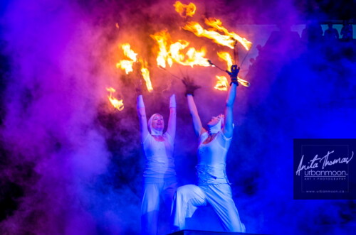 Lifestyle photography - Performers dance with fingers aflame during a performance with Circus Orange at Supercrawl 2013 in Hamilton, Ontario. Scenes captured of the performers and visitors at Supercrawl in Hamilton, Ontario.
© Anita Thomas - Urbanmoon Photography. All Rights Reserved. pyro aerialists