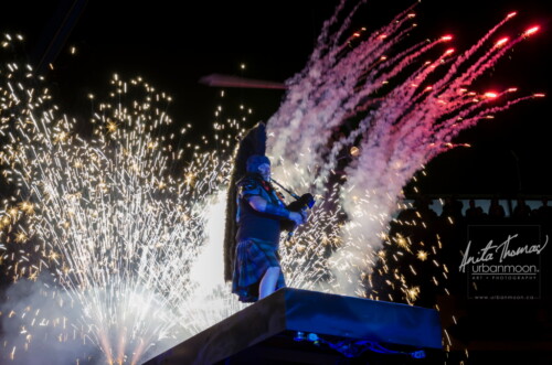 Lifestyle photography - The bagpiper sets the stage afire during a performance with Circus Orange at Supercrawl 2013 in Hamilton, Ontario. Scenes captured of the performers and visitors at Supercrawl in Hamilton, Ontario.
© Anita Thomas - Urbanmoon Photography. All Rights Reserved. pyrotechnics and the bagpipe