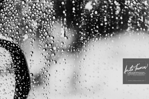Black and white photography - Raindrops on a car window with the side-view mirror on the other side.
© Anita Thomas - Urbanmoon. All Rights Reserved. raindrops on a car window