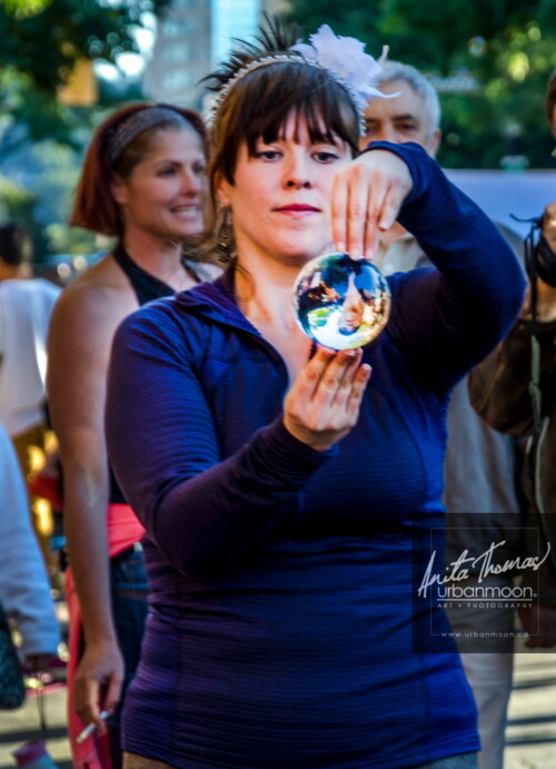 Lifestyle photography - A street performer with her crystal ball at Supercrawl 2013 in Hamilton, Ontario. Scenes captured of the performers and visitors at Supercrawl in Hamilton, Ontario.
© Anita Thomas - Urbanmoon Photography. All Rights Reserved. street performer