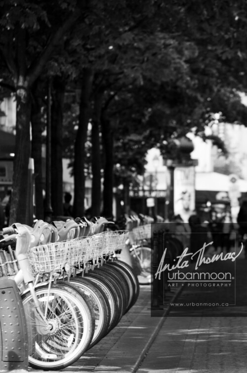 Urban photography - Paris, France
© Anita Thomas - Urbanmoon Photography. All Rights Reserved. street photography rental bicycles are lined up waiting on a s